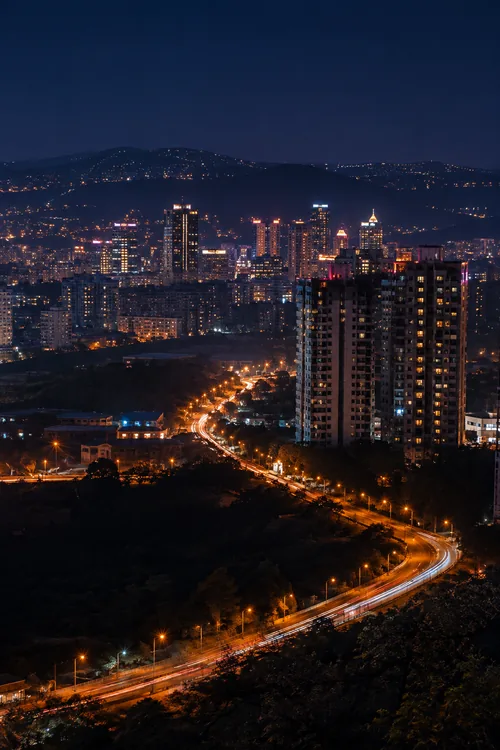 Pune skyline and curving city roadway at night